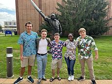 Project HEAT group members pictured outside in front of a statue