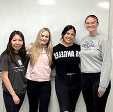 Courtney Castle, Emily Deng, Brooke Hudson and Ivonne Larrea posed against a wall