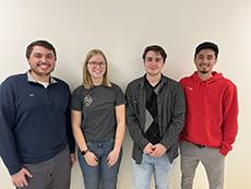 Adam Blank, Adrian Ortiz, Jaeden Sizemore, and Caitlin Zoschke posed against a wall